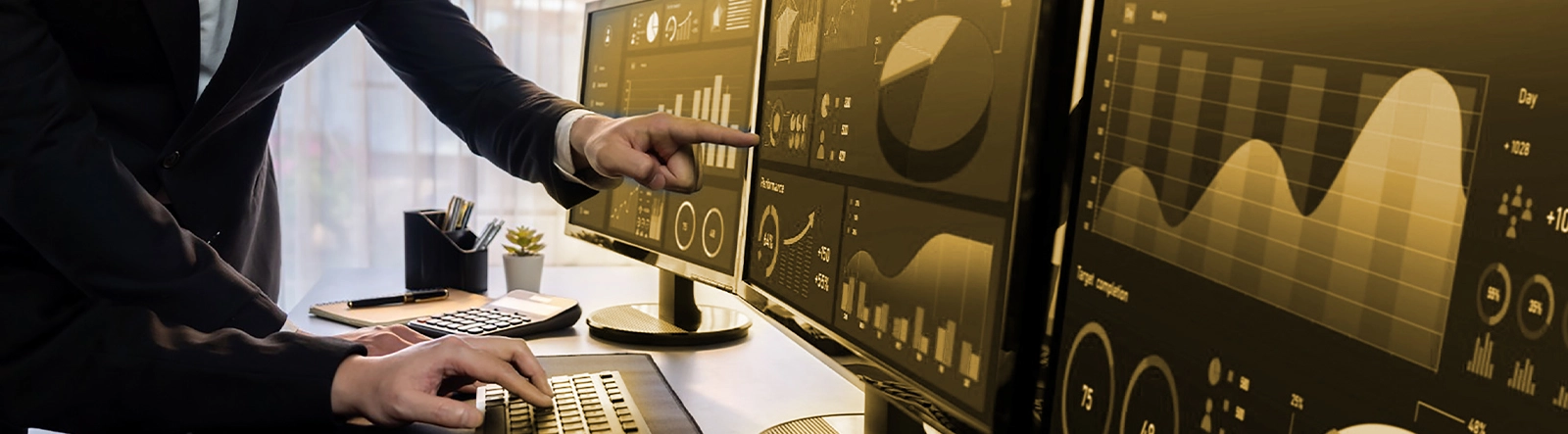 Article cover image depicting a person in a suit pointing at a laptop that shows data in the form of graphs and charts.