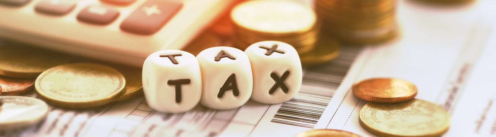 Article cover image depicting blocks that spell out the word 'TAX'.