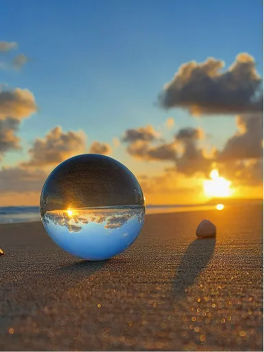 Listing image depicting a drop of water which is against a beach. The drop shows a reverse image of the beach.