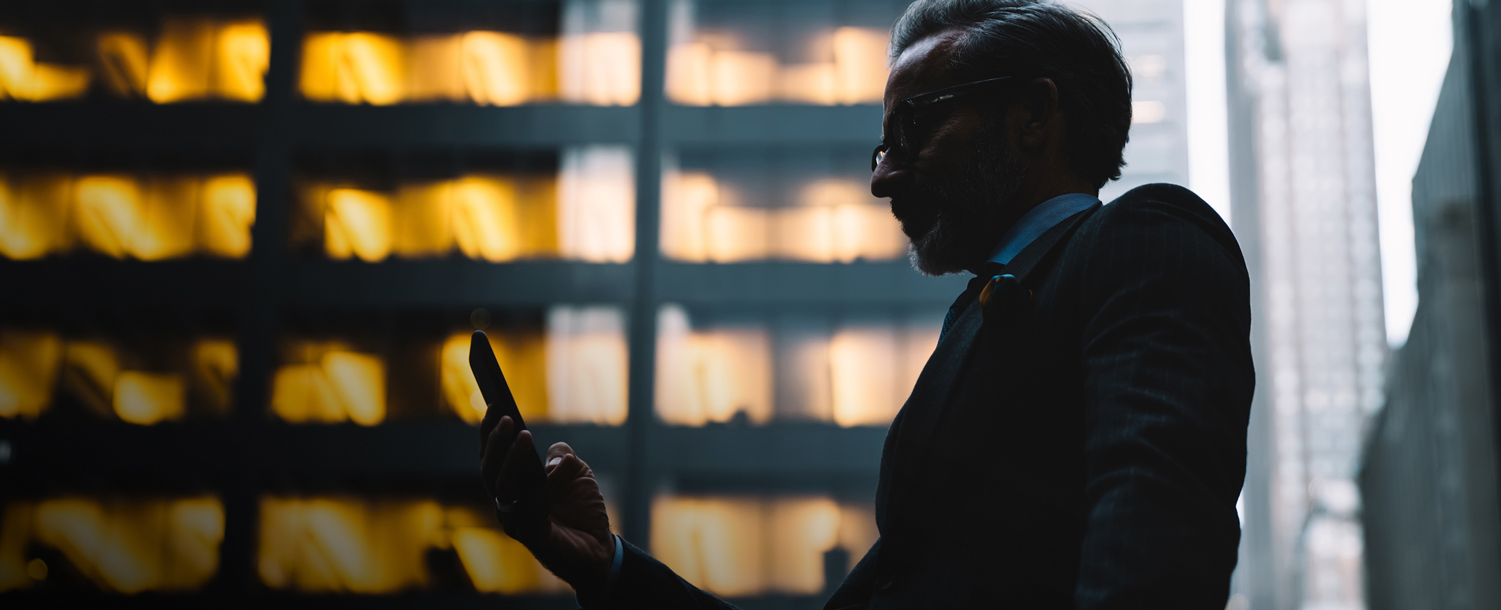 Experience That Sees Beyond Market Cycles Visual of a man looking at his phone.